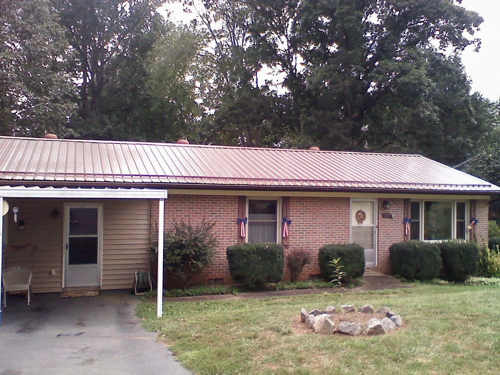 Bronze metal roof and carport on a brick ranch home — Roof Repair work by our crew in Zenia