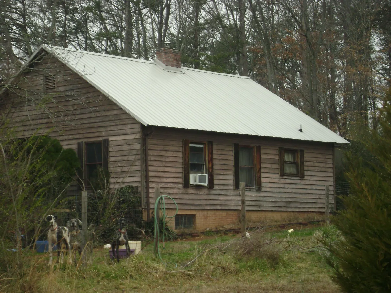 White metal roof on an old wood sided farmhouse, from a Metal Roof Installation job in Zenia